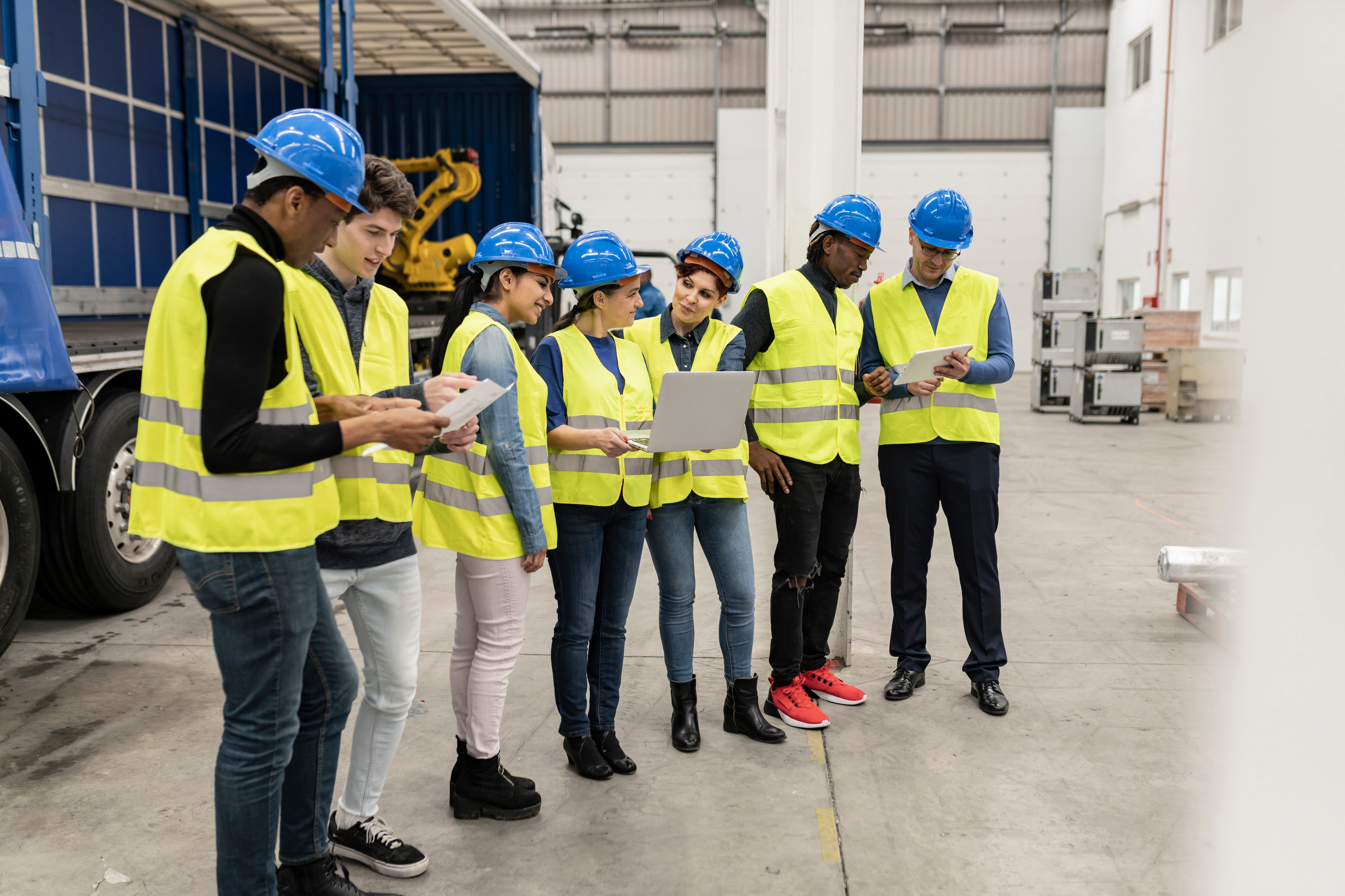 Apprenticeship Recommendations Project group of ingenious workers in robotics, apprentice engineer programming robots in car factory